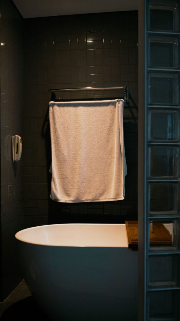 Stylish bathroom featuring a sleek bathtub and towel in Jakarta, Indonesia.