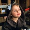 pexels-photo-38950010-38950010 Adorable child in a cozy hooded robe, enjoying a meal at home.