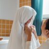 pexels-photo-4474056-4474056 Cheerful ethnic mum wiping cute little daughter with big fluffy towel in modern bathroom at home